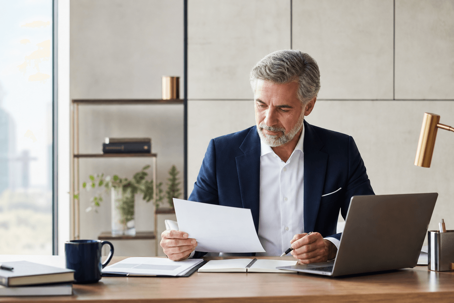 Senior professional reviewing career documents at a desk